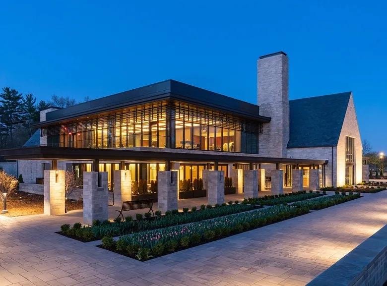 Ford House event pavilion banquet hall with round tables and floor-to-ceiling windows overlooking the water