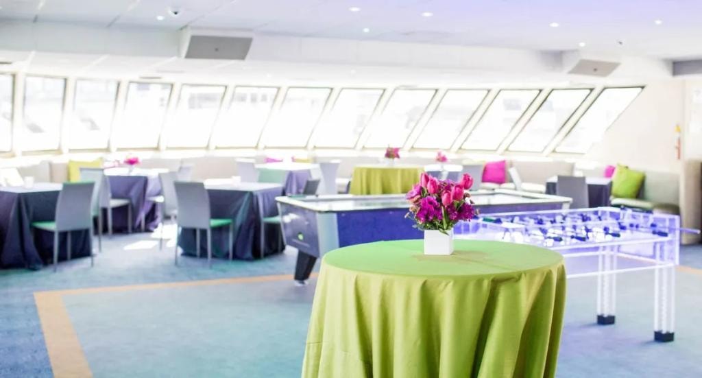 San Francisco Spirit event deck with green-linen cocktail tables and bright natural light