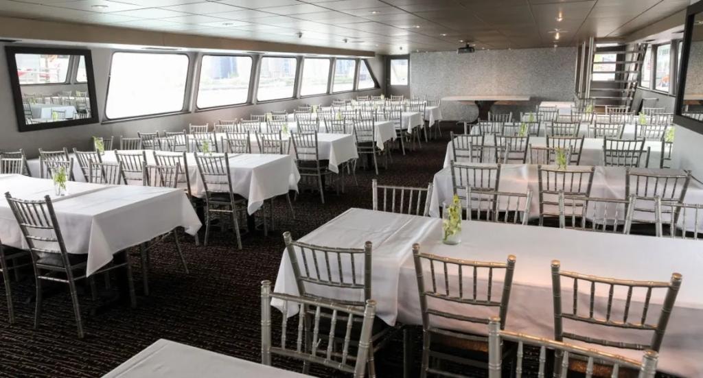 Chicago Elite main event salon with white-linen tables and chiavari chairs